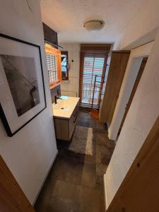 a bathroom with a sink and a mirror at Apartment Ape Maja in Bad Wiessee