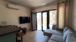 a living room with a couch and a table at 5 srca in Stanići