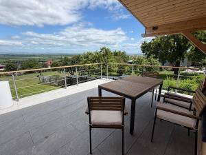 a table and chairs on a balcony with a view at Panorama Chalet Fahner Höhe nahe Erfurt mit Klimaanlage in Witterda