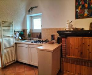 a kitchen with a sink and a stove top oven at Il Nido di Concesio in Concesio