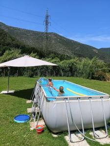 a man and a woman in a boat in a pool at I Cuculi vacation home in Lucca in Lucca