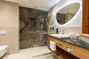 a bathroom with a sink and a shower at Landhaus Grünau in Wals +25 photos