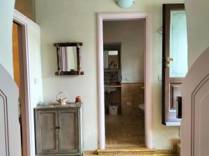 a bathroom with a wooden cabinet and a mirror at Il Nido di Concesio in Concesio