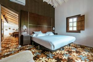 a bedroom with a large bed and a living room at Hotel Granda in Cangas de Onís +155 photos