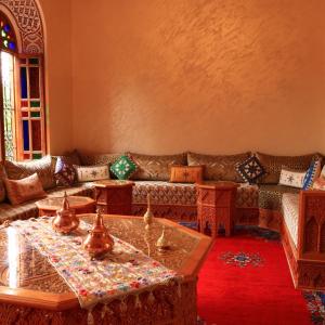 a living room with a couch and tables at Riad Marjana in Marrakesh