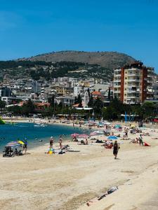 a beach with a bunch of people on the beach at Ajsel Luxury Rooms in Sarandë