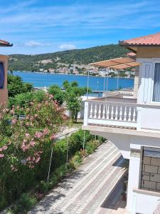 a house with a balcony with a view of the water at Slavica Bunić, Apartments in Supetarska Draga