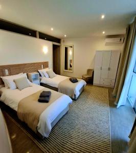 a hotel room with two beds with towels on them at Villa Alexa in Gaios