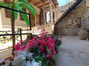 a room with a bunch of flowers on the stairs at Cappadocia Alfa Cave Hotel in Ürgüp