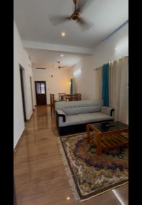 a living room with a couch and a table at Baylio Homestay Varkala in Kappil