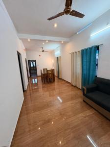 a living room with a couch and a ceiling fan at Baylio Homestay Varkala in Kappil