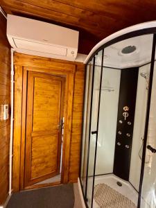 a bathroom with a shower and a wooden door at Bungalow de Quintas in Marco de Canaveses +36 photos