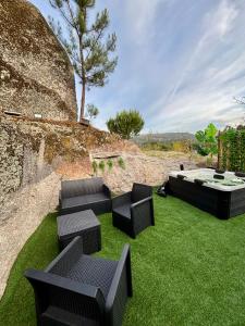 a group of chairs sitting on the grass at Bungalow de Quintas in Marco de Canaveses