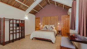 a bedroom with a bed and a wooden floor at Maeva Beach in Sainte Marie