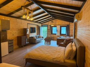 a bedroom with a bed and a living room at بيوت رفال Refal Homes in Ardeşen