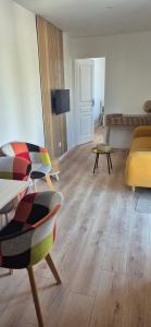 a living room with a couch and a table at Le Nid Charentais in Cognac