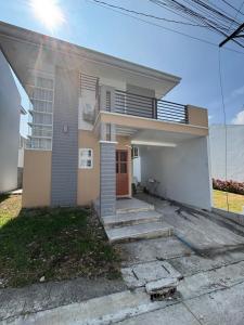 a house with a front porch and a driveway at Arellano Residence in Batangas City