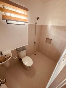 a bathroom with a toilet and a sink at Arellano Residence in Batangas City +14 photos
