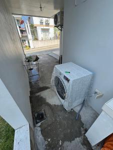 a microwave sitting in the corner of a house at Arellano Residence in Batangas City