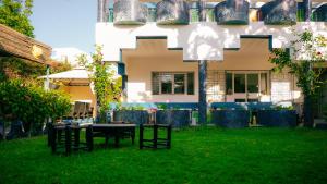 a yard with tables and chairs in front of a building at Maison d'hôtes Kamilia in Ksar es Sghir +40 photos