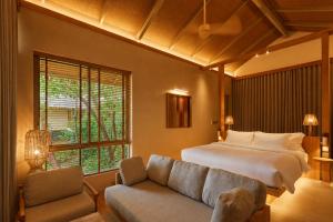 a bedroom with a bed and a couch at Amber Yao Noi in Ko Yao Noi +93 photos