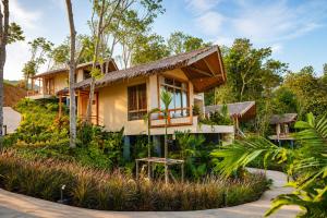 a house in the middle of a garden at Amber Yao Noi in Ko Yao Noi