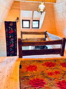 a bedroom with a bed and a rug on a wooden floor at Hafia Legacy in Berbeşti