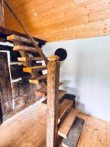 a spiral staircase in a room with wooden ceilings at Hafia Legacy in Berbeşti +7 photos