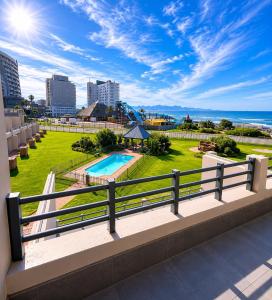 a balcony with a view of a pool and the ocean at Diaz De Valle 35 in Mossel Bay