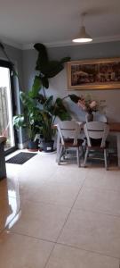 a room with a table and chairs and plants at Double Bed in Loft Space with En Suite in Loughrea