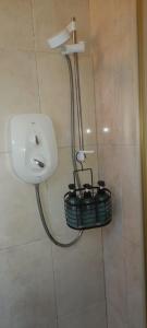 a bathroom with a shower with a basket on the wall at Double Bed in Loft Space with En Suite in Loughrea