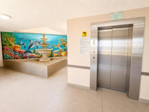 an elevator in a building with a painting on the wall at Diaz De Valle 35 in Mossel Bay +41 photos