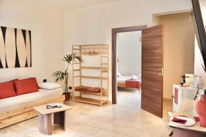 a living room with a couch and a table at Taga Suites in Catania