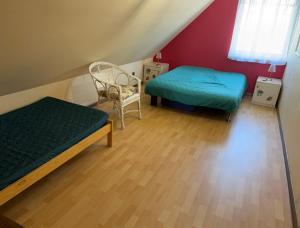 a small room with two beds and a chair at Gorczyca Reset in Płaska