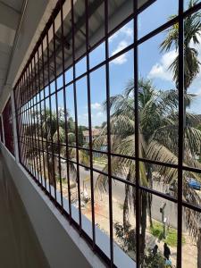 a window in a building looking out at the beach at Mousumi Lodge in Tezpur