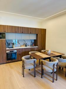 a dining room with a table and chairs and a kitchen at Monaco - Menton Old Town - Climatisation - Seaview - Luxury rénovation in Menton