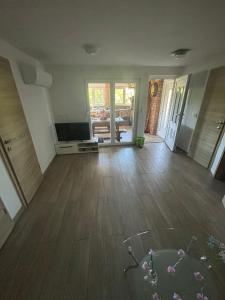 an empty living room with a television and wooden floors at Jelica in Polje