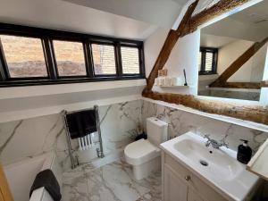 a bathroom with a toilet and a sink at City Rooms by Hiive in Worcester +149 photos