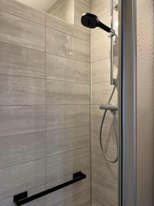 a shower with a shower head in a bathroom at Fewo Helene im Haus Moselwelt in Zell an der Mosel +35 photos