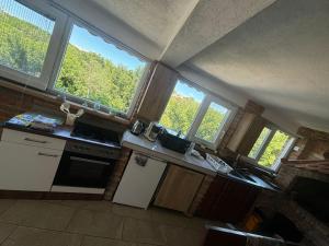 a kitchen with four windows and a counter top at Jelica in Polje