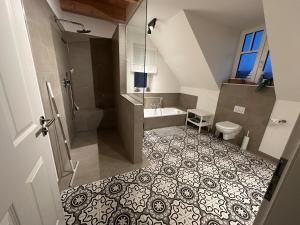 a bathroom with a shower and a sink and a toilet at Linnebarg Hus 4 in Fehmarn +37 photos