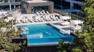 an overhead view of a swimming pool with lounge chairs at Hotel Shellter Resort & Spa in Rogowo