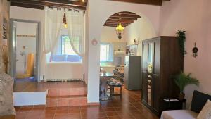 a living room with a kitchen and a bedroom at Persephone's Home in Skala