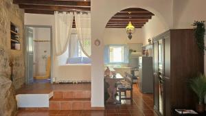 a room with a kitchen and a bedroom with a bed at Persephone's Home in Skala