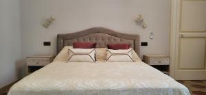 a bedroom with a large bed with two pillows at CasaSignorina in Leuca