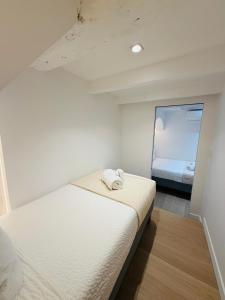 a white room with a bed and a window at Monaco - Menton Old Town - Climatisation - Seaview - Luxury rénovation in Menton