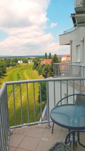 a balcony with a table and a view of a field at WING 3 apartman ,,BC ,, in Jagodina