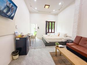 a living room with a bed and a couch at Three CoCo Villa AoNang Beach in Ao Nang 