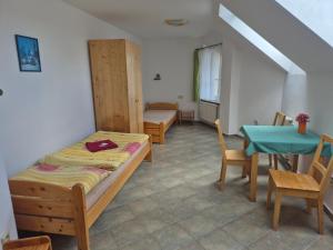 a room with a bed and a table and chairs at Pension Camp Prager in Prague