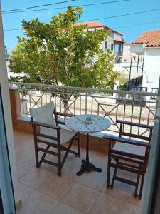 a table and two chairs on a balcony at Pfaffenhofen in Nea Vrasna +32 photos